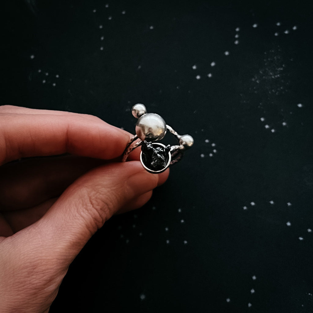 Celestial Orbital Style | CLEARANCE Cosmic Ring Crafted with Genuine Meteorite Fragment | Space Jewelry Ring with Orbit Motif and Authentic Meteorite | Unique Meteorite Ring for Astronomy and Science Enthusiasts | Celestial Orbit Ring with Real Meteorite from Outer Space | Statement Ring with Meteorite and Cosmic Motion Design | Orbiting Cosmic Bodies Ring with Rare Meteorite Stone | Meteorite Jewelry Gift for Space, Planet, and Star Lovers | Genuine Space Rock Ring in a Stylish Orbit-Inspired Setting