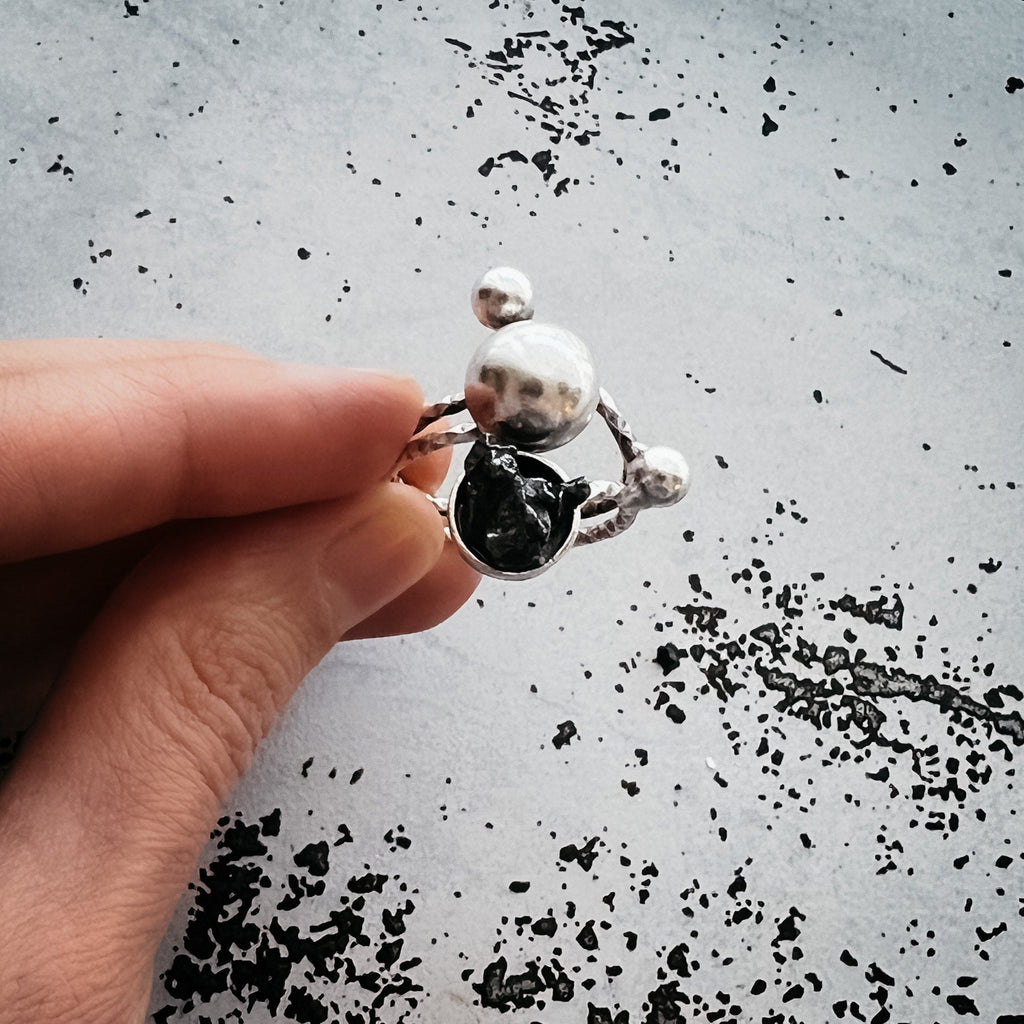 Celestial Orbital Style | CLEARANCE Cosmic Ring Crafted with Genuine Meteorite Fragment | Space Jewelry Ring with Orbit Motif and Authentic Meteorite | Unique Meteorite Ring for Astronomy and Science Enthusiasts | Celestial Orbit Ring with Real Meteorite from Outer Space | Statement Ring with Meteorite and Cosmic Motion Design | Orbiting Cosmic Bodies Ring with Rare Meteorite Stone | Meteorite Jewelry Gift for Space, Planet, and Star Lovers | Genuine Space Rock Ring in a Stylish Orbit-Inspired Setting